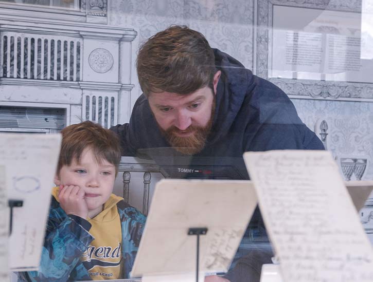 A guy and child admiring in a museum